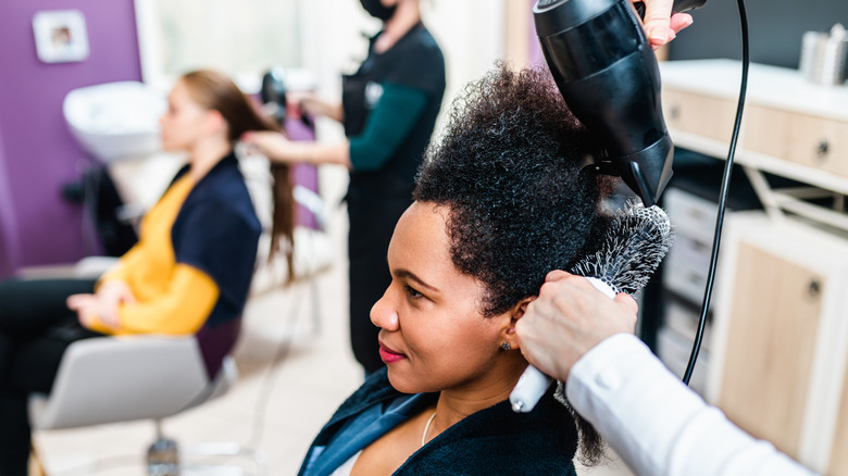 Woman having hair blow dried
