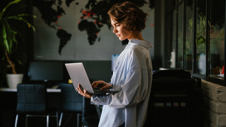 Woman assesses information on laptop