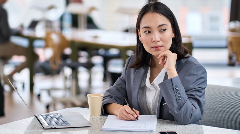woman analyzing and taking notes