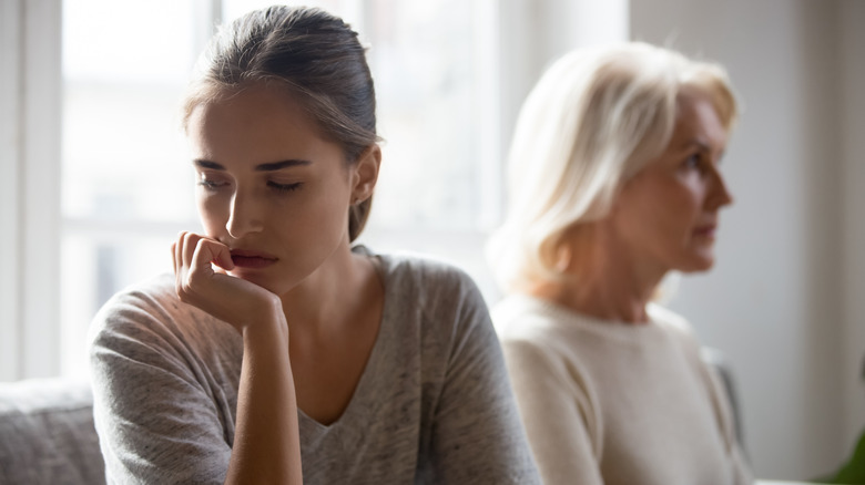 two woman sitting on couch