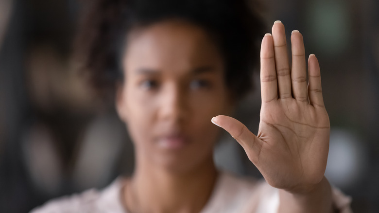 woman holding up hand