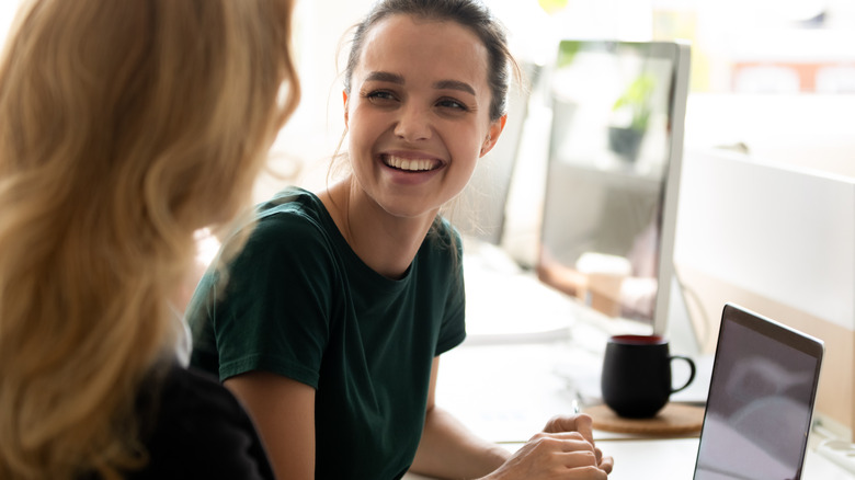 young woman speaking to female coach