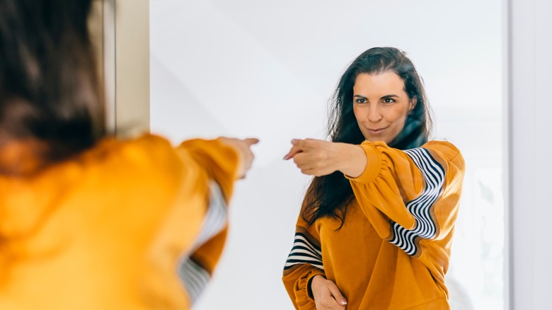 Woman motivates herself in mirror