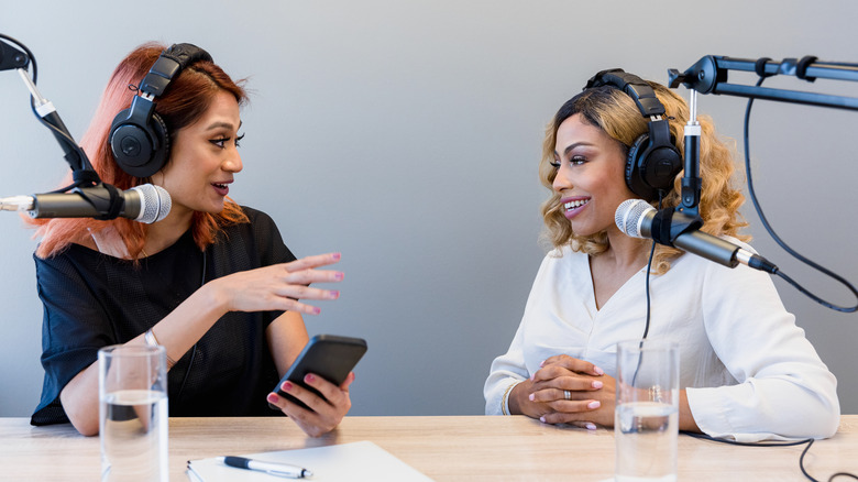 Two women recording a podcast