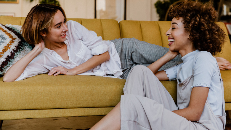 Couple chats in living room 