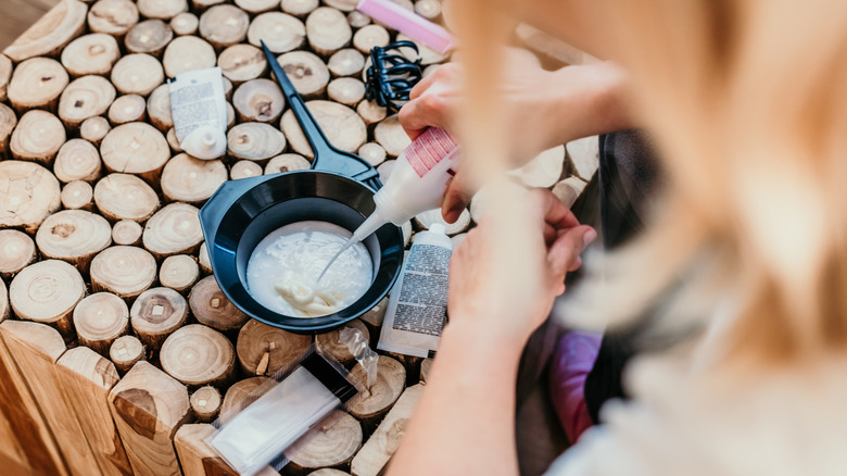 A woman preparing hair products