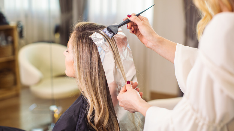 A woman getting her hair bleached