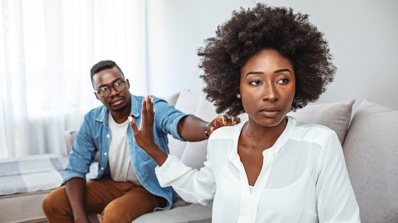 Woman turning away from man