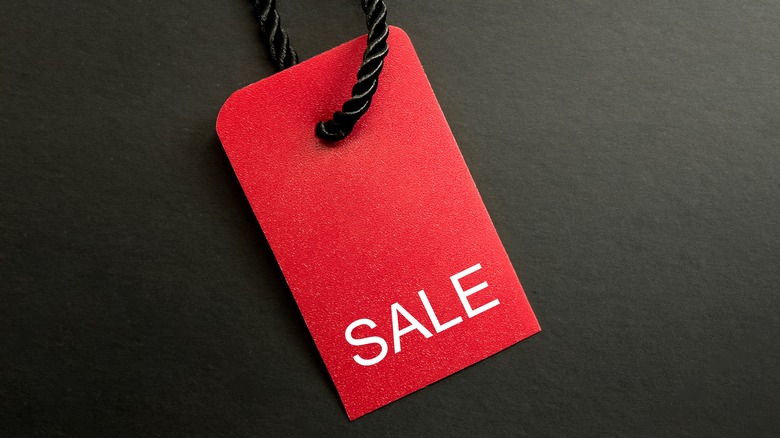 Red sale tag on black background