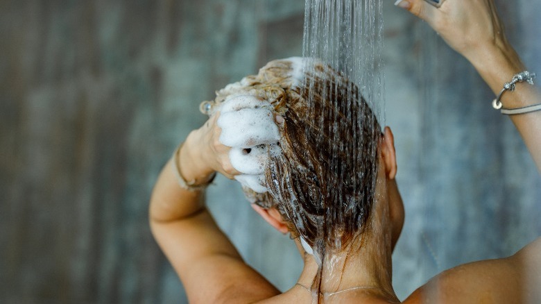Woman washing hair in shower
