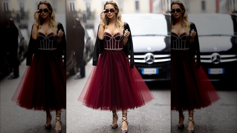 Woman wearing red tulle skirt and velvet bustier