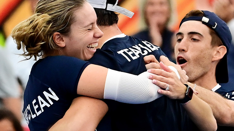 Smiling, hugging pickleball team