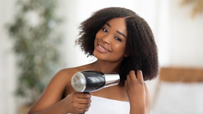 Woman blow drying her hair