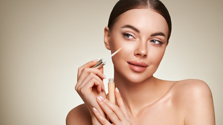 woman using concealer 