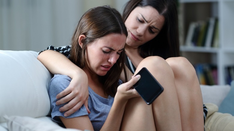 Crying girl comforted by friend