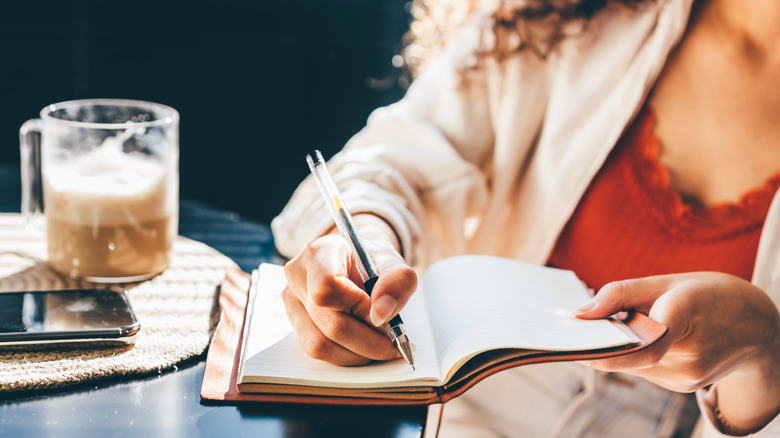 Woman writing in a journal