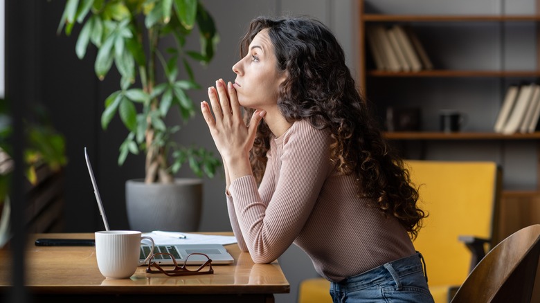 A stressed woman sitting at desk