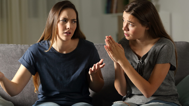 Girl annoying her friend