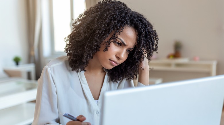 confused woman looking at laptop