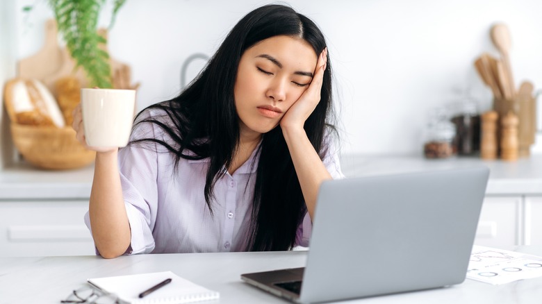 tired woman working with coffee