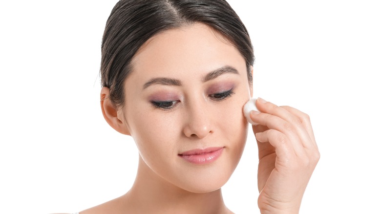 woman using cotton ball 