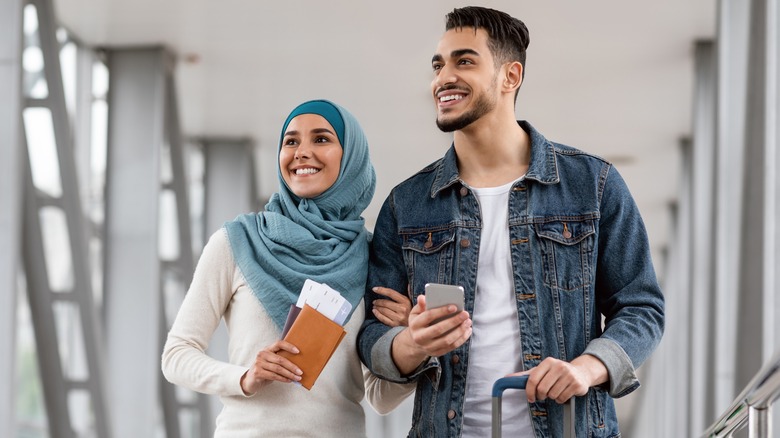 Middle-eastern couple traveling in airport