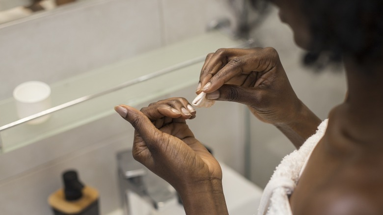 woman touching up her nails