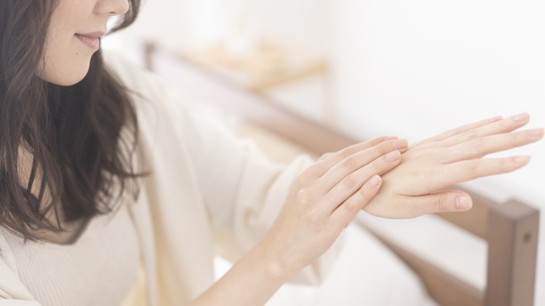 woman looking at her hands