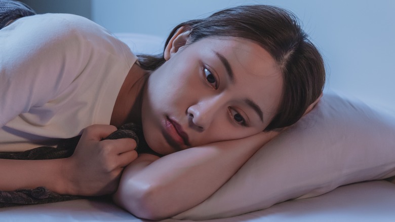 woman in bed thinking