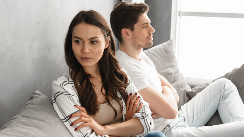Young couple facing opposite directions