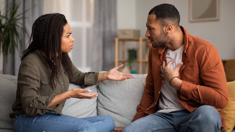 couple arguing on couch
