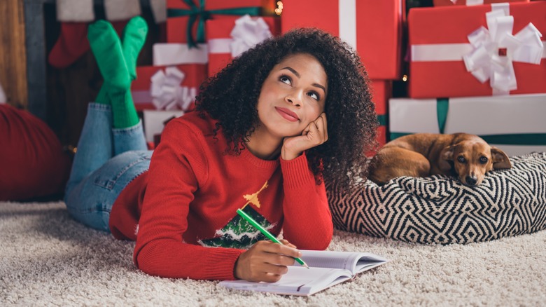 Woman thinking near christmas tree
