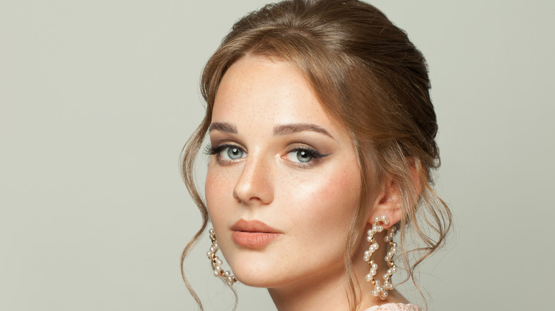 Woman with an updo and earrings