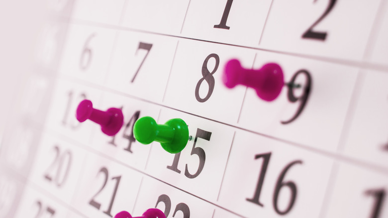 Calendar with thumbtacks up close