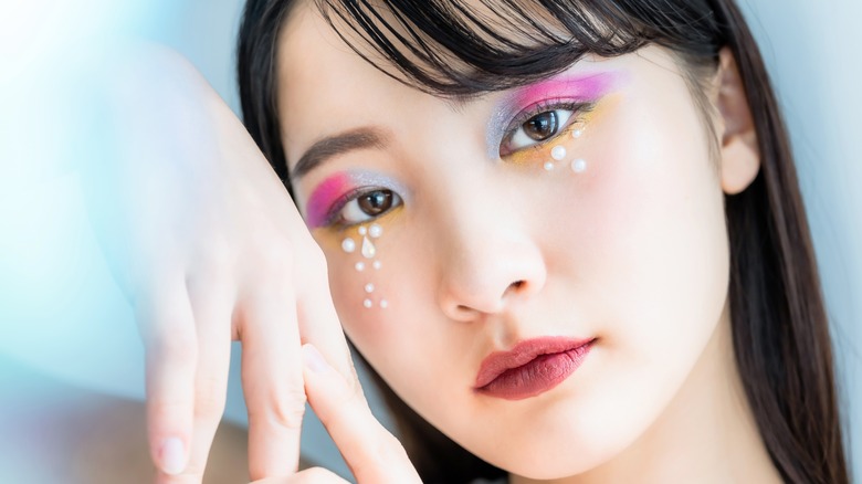 Model with pearls below eyes