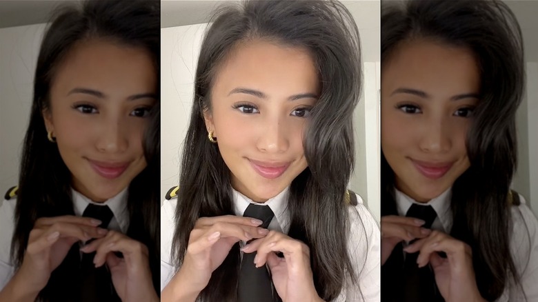 pilot fixing her tie 