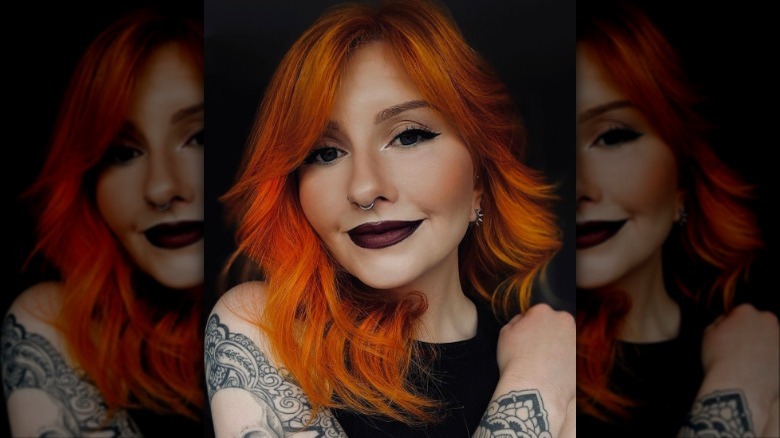 A woman with winged eyeliner and dark lipstick