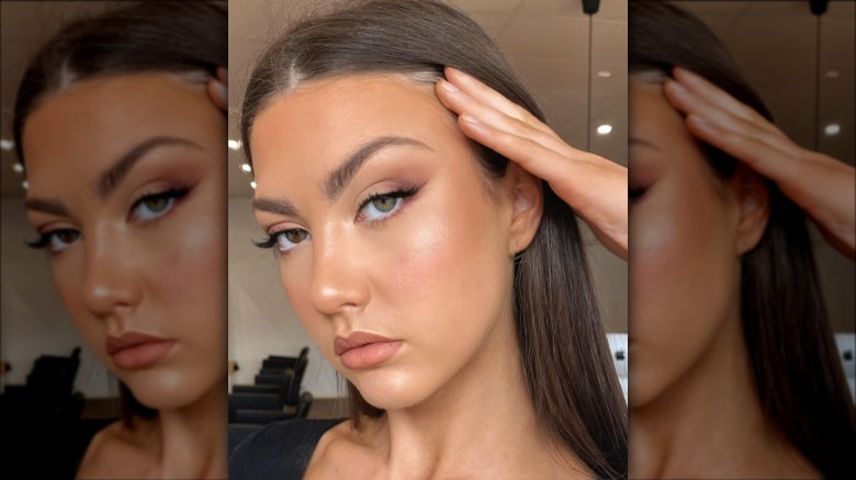 A woman with brown eyeshadow and thin eyeliner wings