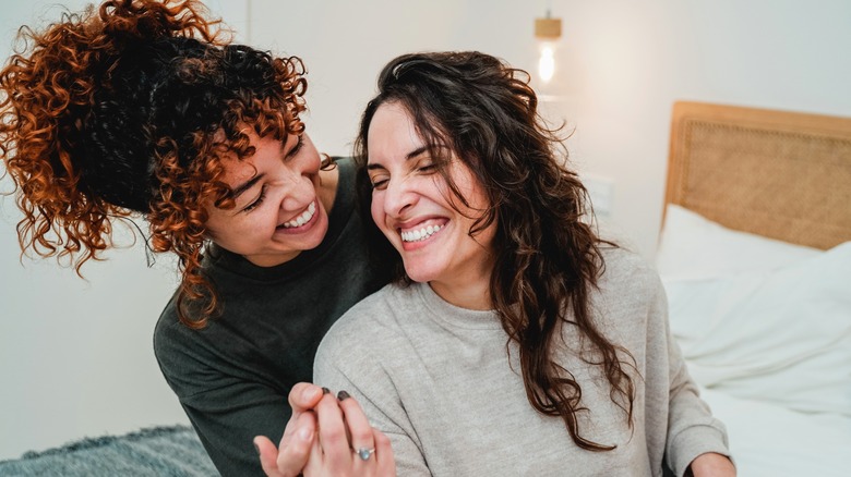 Couple smiling on bed