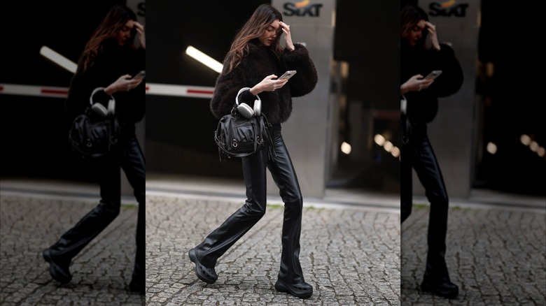 A woman wearing flared pants with platform shoes.