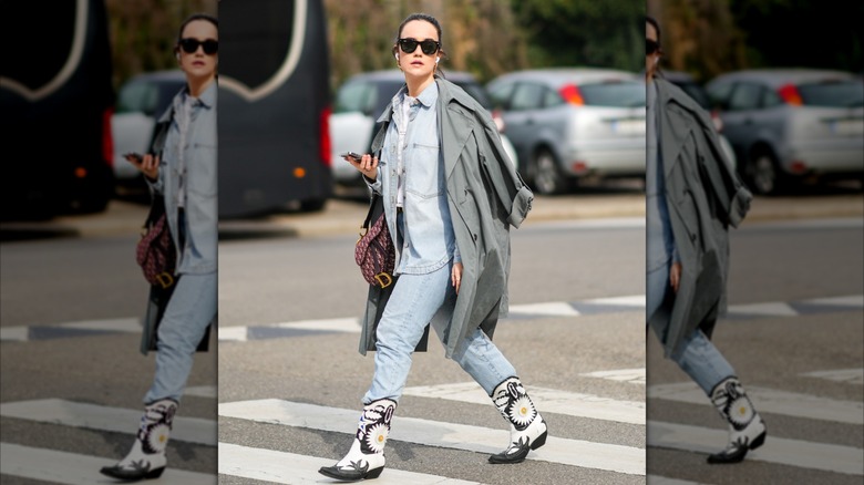 A woman wearing jeans tucked into cowboy boots.