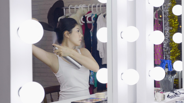 A woman using hair spray