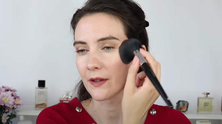 Applying blush with large brush