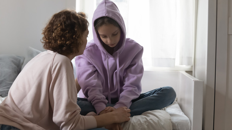 Mother has discussion with daughter