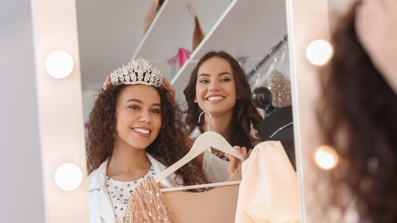 Woman trying on prom dresses