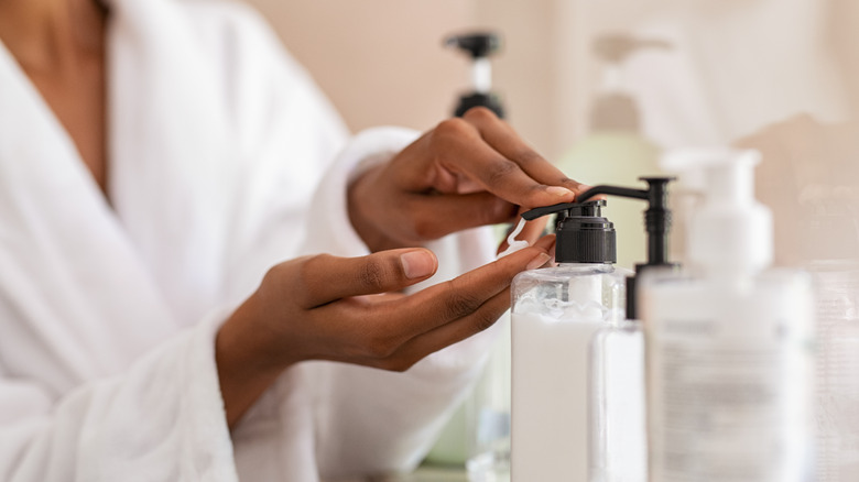 woman putting on hand lotion