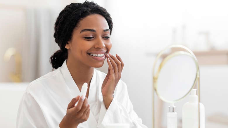 Woman applying lip balm
