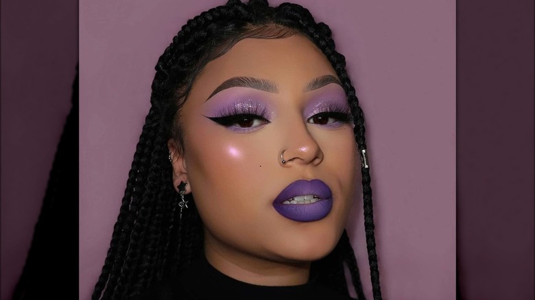 A woman with purple makeup