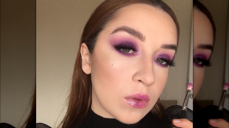 A woman with purple makeup