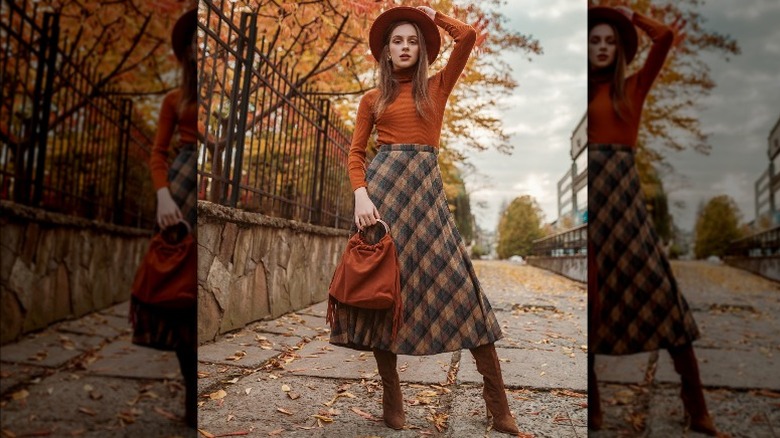 woman posing in midi skirt and sweater